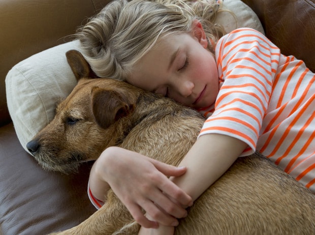 Girl hugging a dog